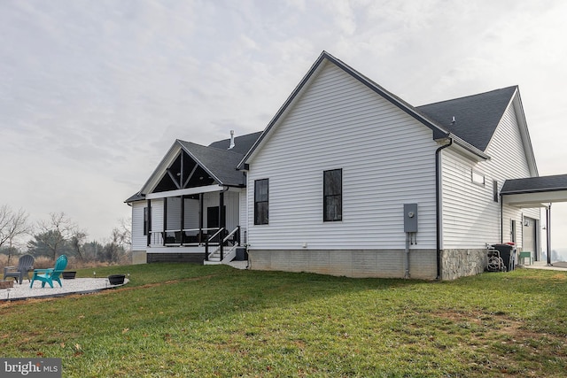 back of house featuring a patio area and a yard