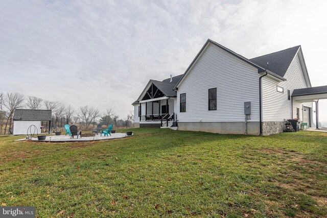 exterior space featuring a patio area, a yard, a shed, and an outdoor structure