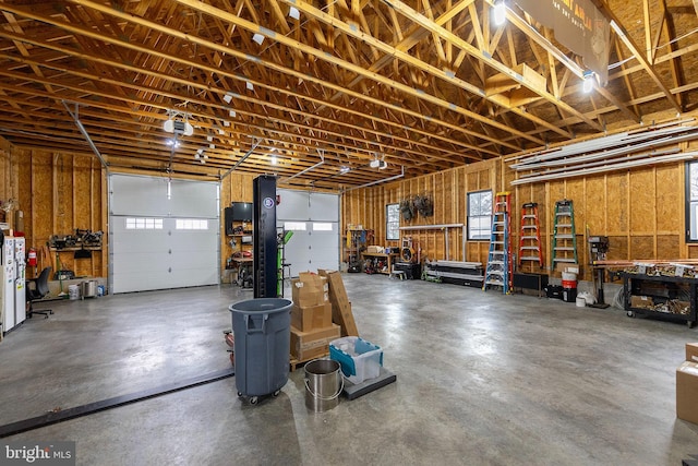 garage featuring a garage door opener and a workshop area