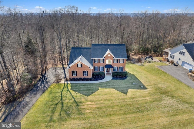 drone / aerial view featuring a wooded view