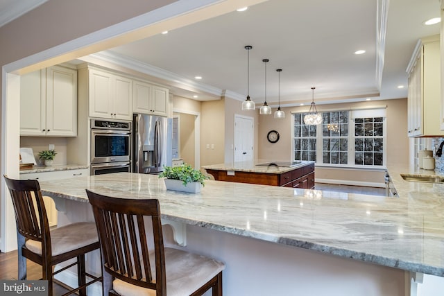 kitchen featuring light stone counters, recessed lighting, stainless steel appliances, a sink, and crown molding