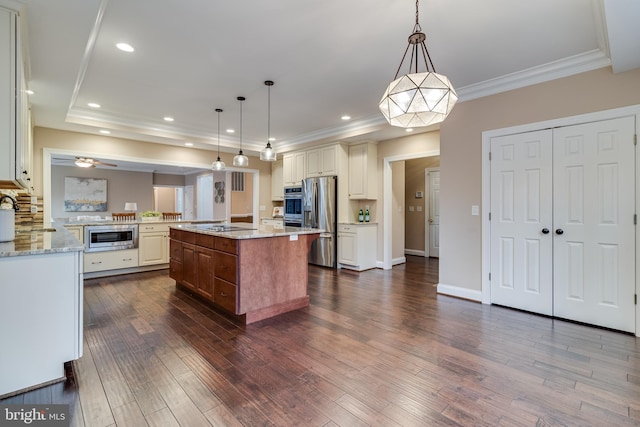 kitchen featuring dark wood-style floors, crown molding, appliances with stainless steel finishes, and light stone counters