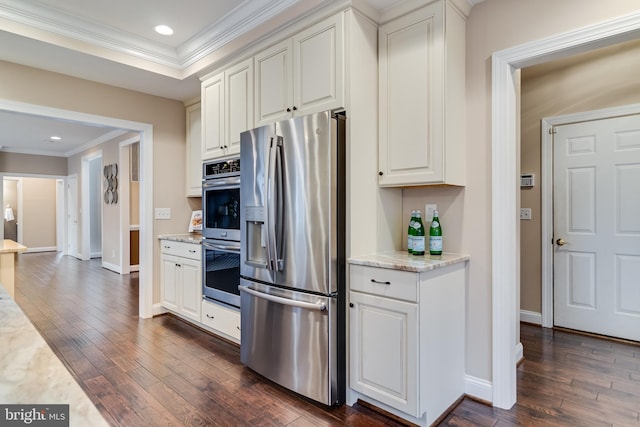 kitchen featuring dark wood-style floors, appliances with stainless steel finishes, white cabinetry, and crown molding