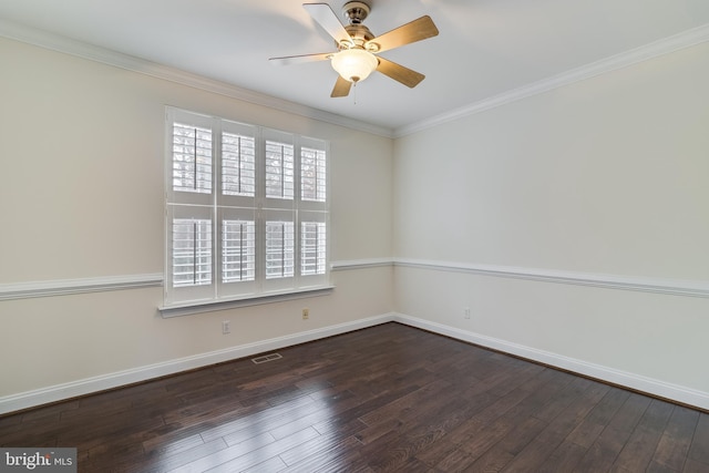 empty room featuring wood-type flooring, visible vents, crown molding, and baseboards