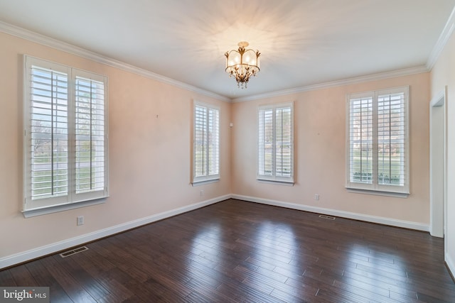 empty room featuring plenty of natural light, wood-type flooring, visible vents, and ornamental molding