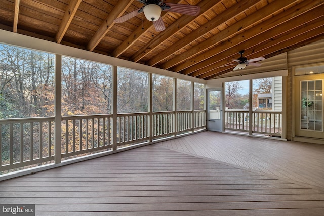 unfurnished sunroom with lofted ceiling with beams, ceiling fan, and wooden ceiling