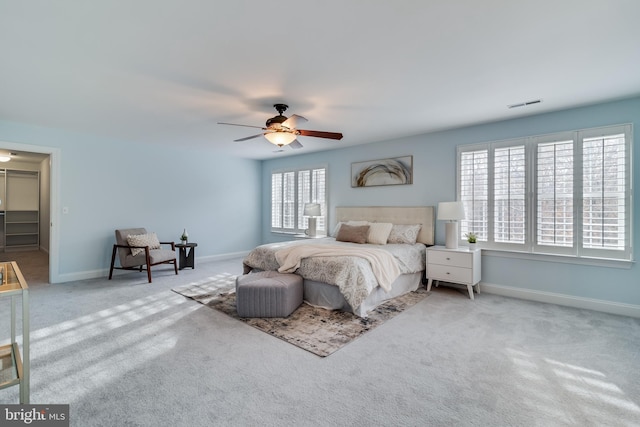 bedroom with baseboards, visible vents, ceiling fan, and carpet flooring