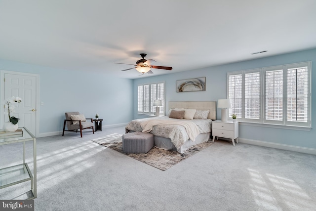 bedroom with carpet floors, visible vents, ceiling fan, and baseboards