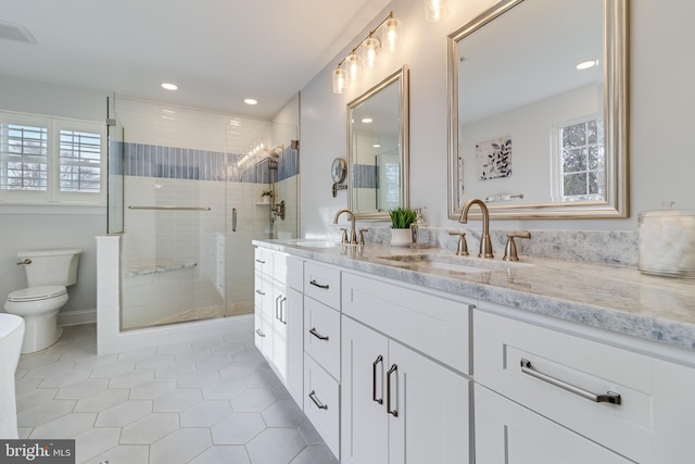 full bath featuring a wealth of natural light, a sink, and a stall shower