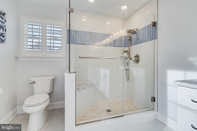 bathroom featuring tile patterned flooring, toilet, vanity, baseboards, and a shower stall