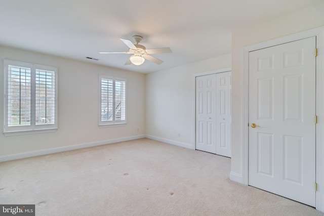 unfurnished bedroom with baseboards, a closet, visible vents, and carpet flooring