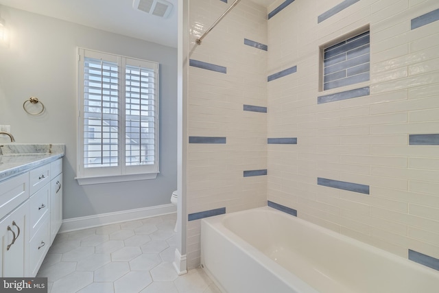 bathroom featuring baseboards, visible vents, toilet, tile patterned floors, and vanity