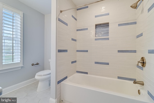 bathroom featuring bathing tub / shower combination, tile patterned flooring, toilet, and baseboards