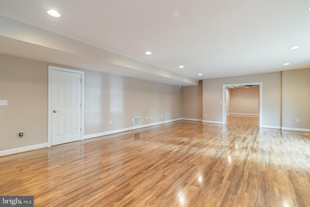 empty room with light wood-type flooring, visible vents, baseboards, and recessed lighting