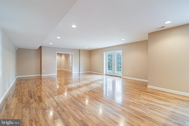 empty room with light wood-type flooring, recessed lighting, visible vents, and french doors