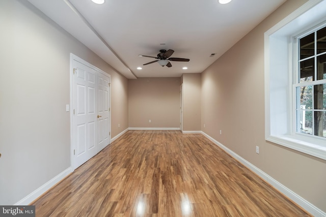 unfurnished room with visible vents, baseboards, light wood-style flooring, ceiling fan, and recessed lighting