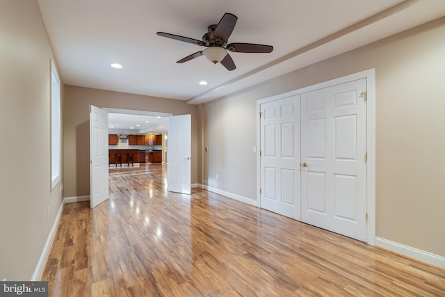 unfurnished living room featuring ceiling fan, recessed lighting, light wood-type flooring, and baseboards