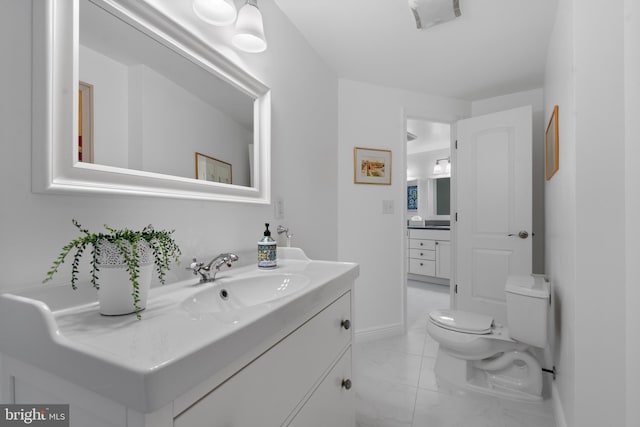 bathroom with marble finish floor, visible vents, toilet, vanity, and baseboards