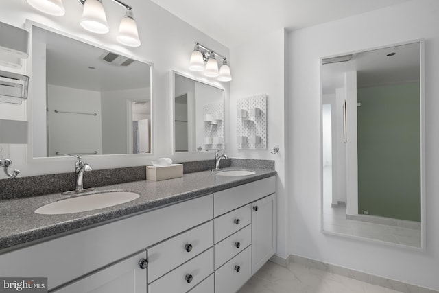 bathroom featuring double vanity, marble finish floor, visible vents, and a sink