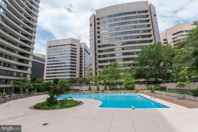 community pool featuring a patio area and fence