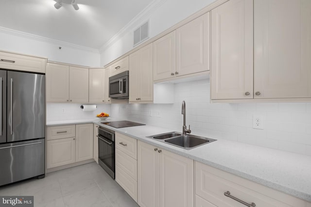 kitchen with tasteful backsplash, visible vents, ornamental molding, black appliances, and a sink