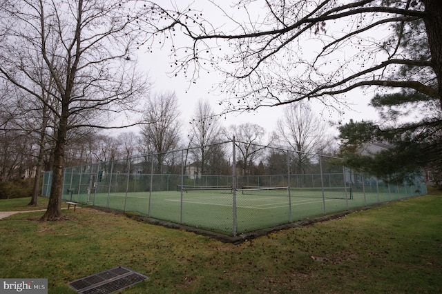 view of sport court featuring a lawn and fence