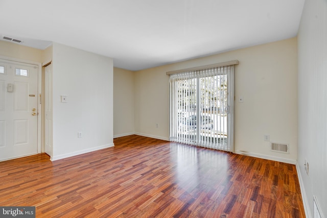 interior space featuring visible vents, baseboards, and wood finished floors