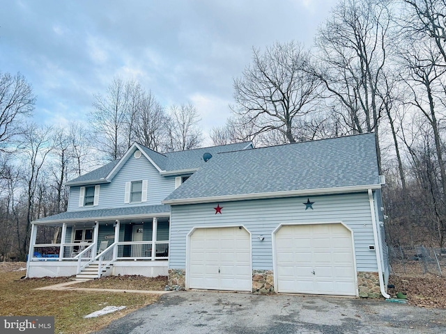 view of front of home with covered porch, an attached garage, driveway, and roof with shingles