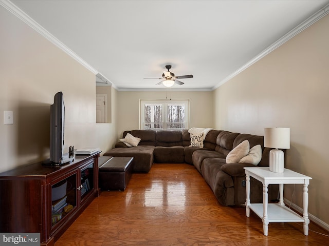 living area with wood finished floors, a ceiling fan, and ornamental molding