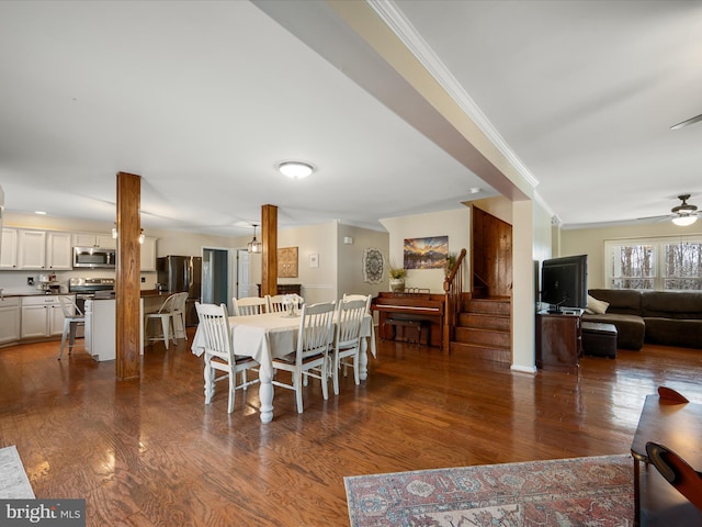 dining area with stairway, crown molding, a ceiling fan, and wood finished floors