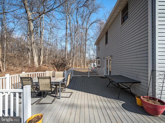 wooden terrace with outdoor dining area