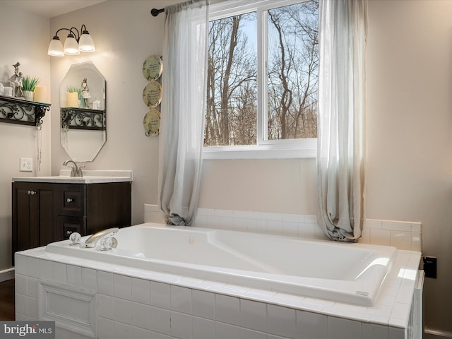 bathroom featuring vanity and a garden tub