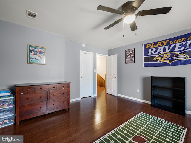 bedroom featuring visible vents, baseboards, and dark wood-style flooring