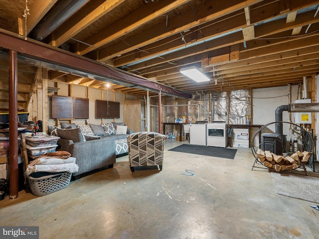 unfinished below grade area featuring washer and dryer