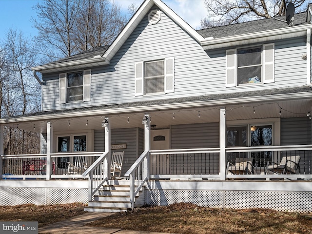 farmhouse-style home with covered porch and a shingled roof