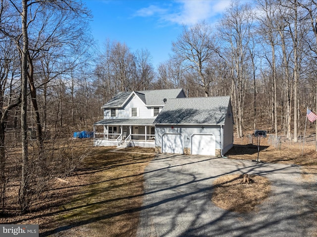 view of front of property featuring aphalt driveway, covered porch, an attached garage, and a shingled roof