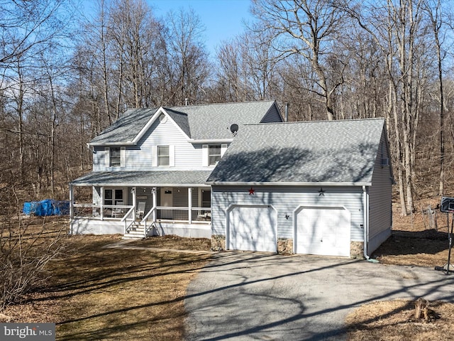 view of front of house with a shingled roof, a porch, an attached garage, and aphalt driveway