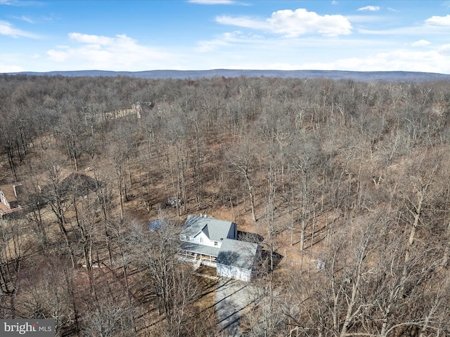 birds eye view of property featuring a view of trees