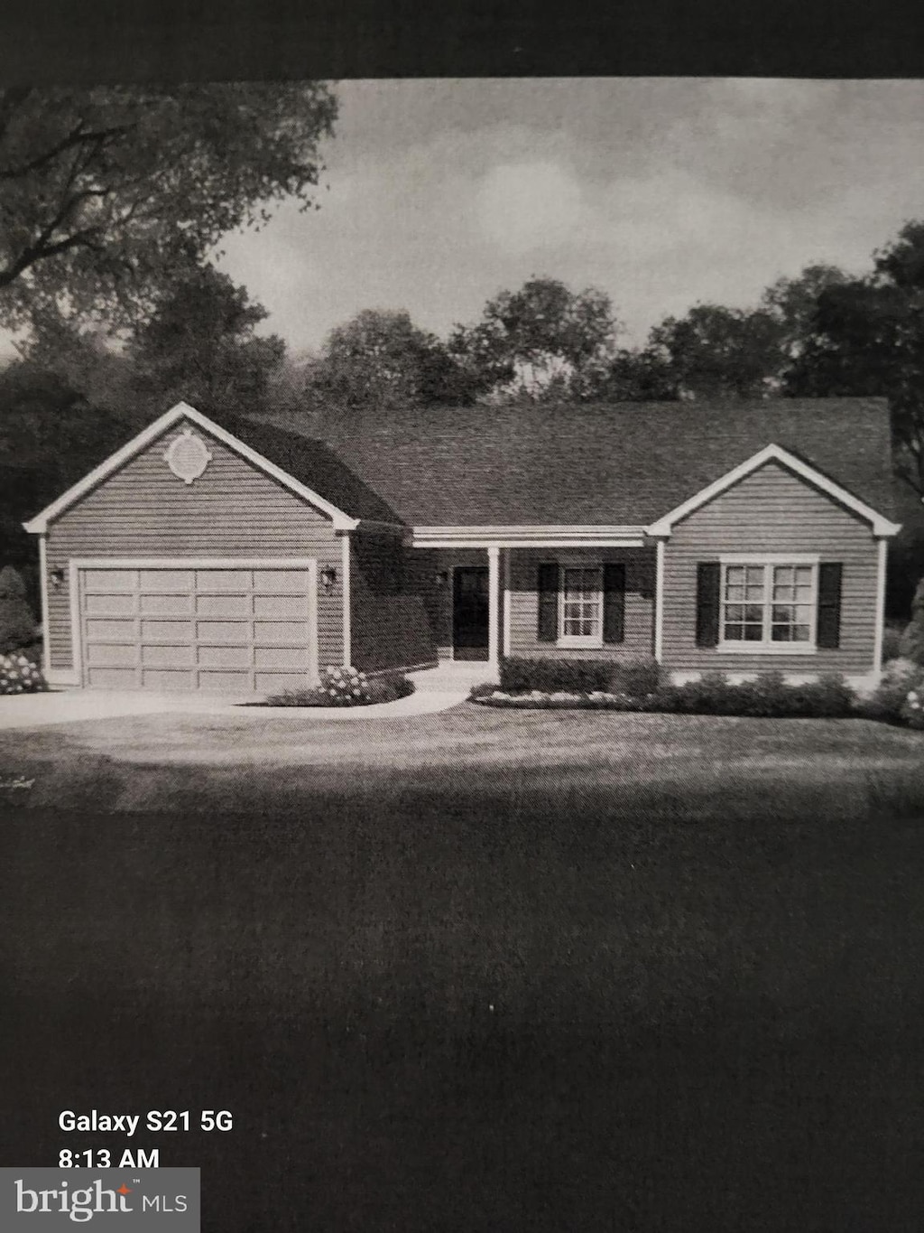 ranch-style home featuring an attached garage and driveway