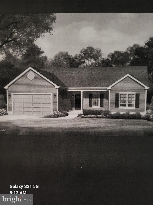 ranch-style home featuring an attached garage and driveway