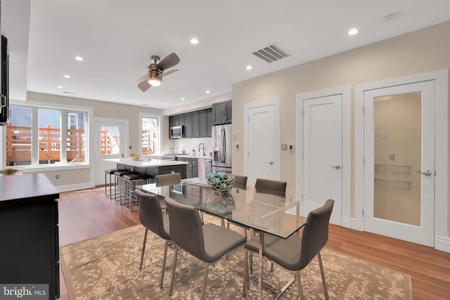 dining room featuring light wood-type flooring, visible vents, and recessed lighting