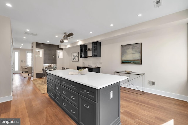 kitchen with a center island, visible vents, and light wood-style floors