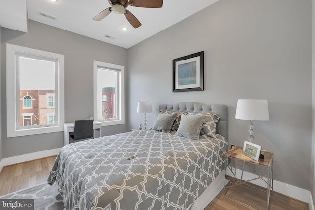 bedroom with baseboards, visible vents, wood finished floors, and recessed lighting