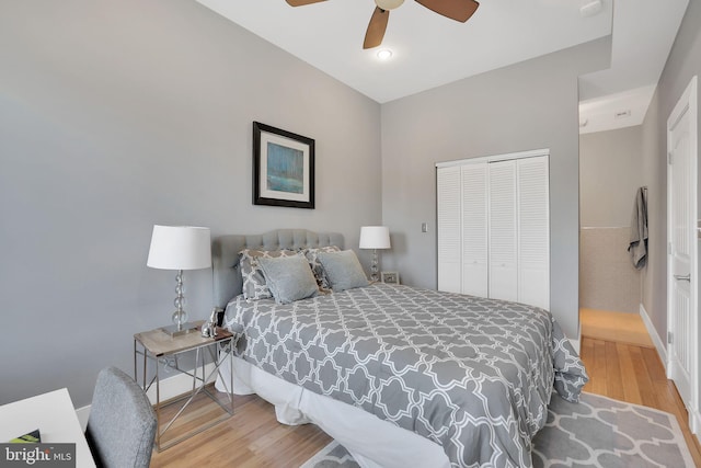 bedroom with a ceiling fan, a closet, and wood finished floors