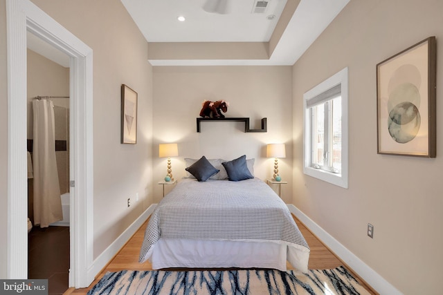 bedroom featuring baseboards, visible vents, wood finished floors, and recessed lighting