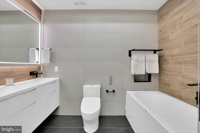 bathroom with toilet, visible vents, tile walls, vanity, and a bath