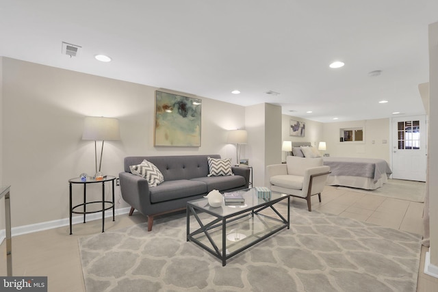 living room with baseboards, visible vents, and recessed lighting