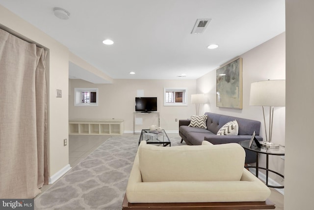 living room with recessed lighting, visible vents, and baseboards