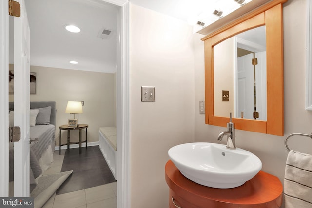 bathroom featuring recessed lighting, visible vents, a sink, tile patterned flooring, and baseboards