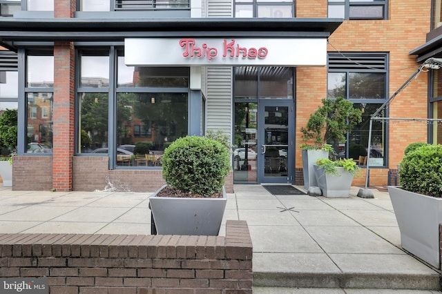 view of exterior entry featuring brick siding